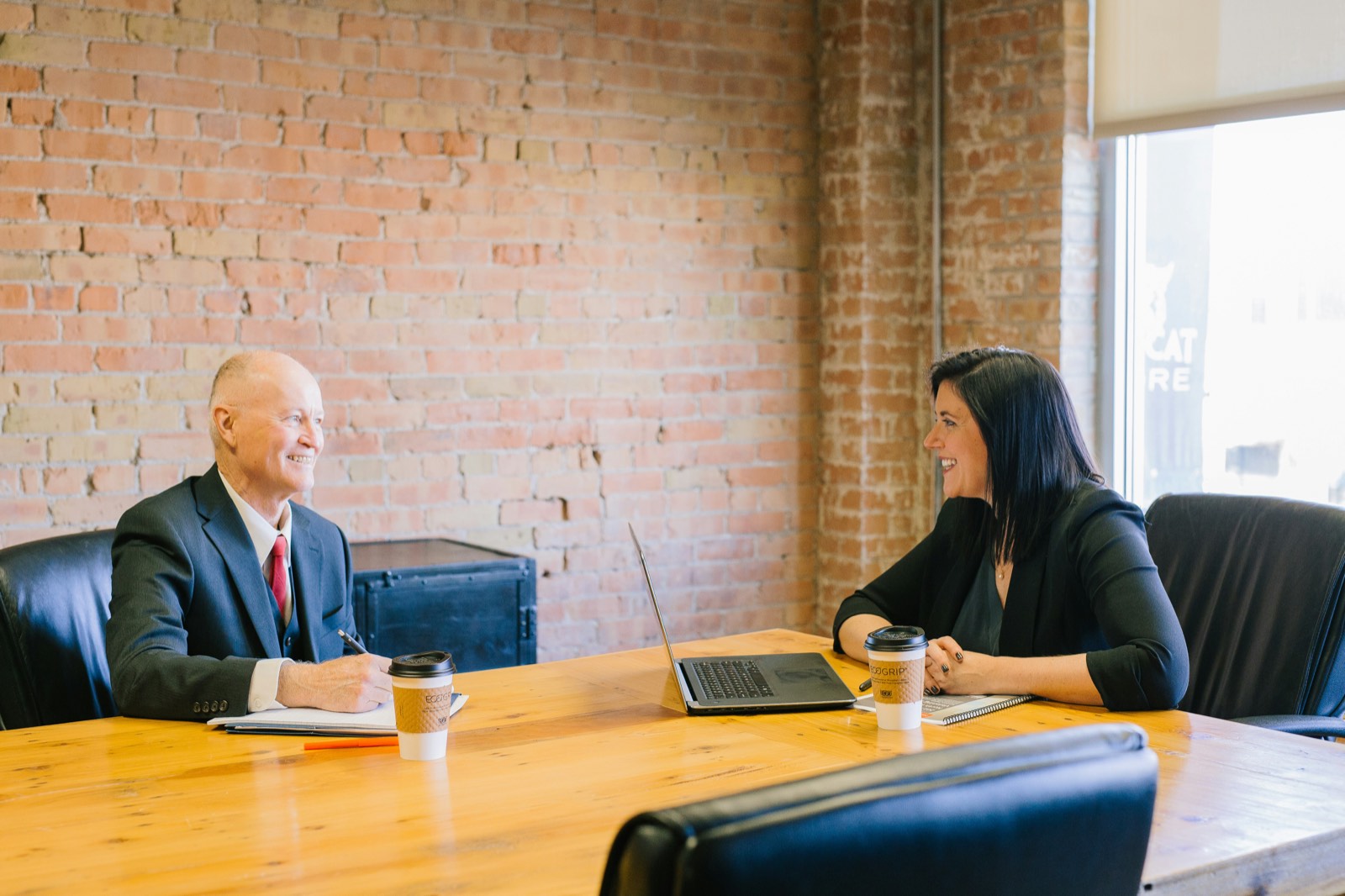 Senior HR adviser and business owner in a calm focused office conversation